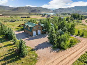 Drone / aerial view with a water and mountain view and a rural view
