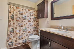 Full bath featuring vanity, tile patterned floors, a shower with curtain, and toilet