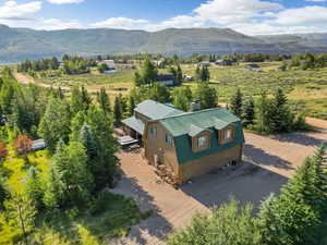 Aerial view featuring a rural view and a mountain view