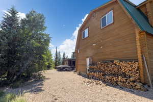 View of home's exterior with log exterior and metal roof