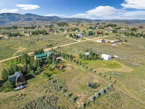 Birds eye view of property with a mountain view and a rural view