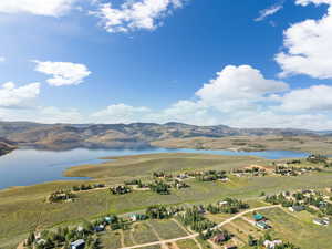 Birds eye view of property featuring a water and mountain view