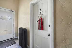 Doorway to property with radiator heating unit