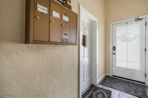 Entryway featuring baseboards and tile patterned flooring