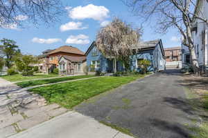 View of front of home with stucco siding, a residential view, and a front lawn