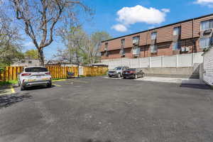 Uncovered parking lot featuring fence