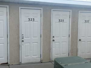 View of exterior entry featuring stucco siding