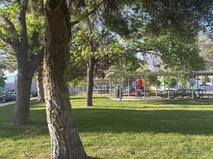 View of home's community with a lawn and playground community
