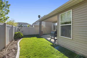 View of yard with a patio area and a fenced backyard
