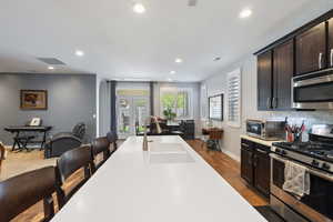 Kitchen featuring a sink, stainless steel appliances, visible vents, recessed lighting, and light countertops