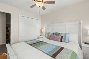 Bedroom with a ceiling fan and a closet