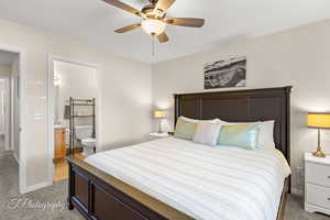 Bedroom featuring connected bathroom, a ceiling fan, baseboards, and light colored carpet