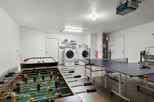 Playroom featuring water heater and washing machine and clothes dryer