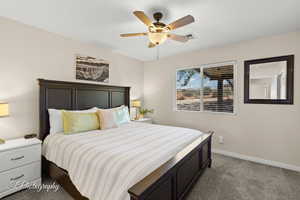 Bedroom with baseboards, carpet, ceiling fan, and visible vents