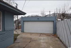 Detached garage featuring fence