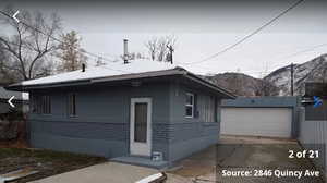 View of front of home featuring an outdoor structure, a mountain view, and a garage
