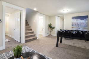 Game room featuring baseboards, visible vents, and carpet