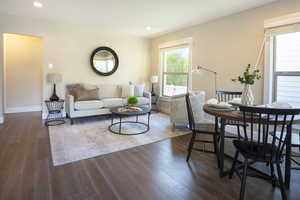 Living room featuring baseboards, recessed lighting, and dark wood-type flooring