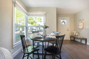 Dining space featuring baseboards and dark wood-style floors