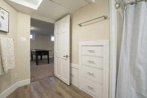 Hallway with baseboards and wood finished floors
