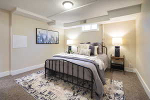 Carpeted bedroom with baseboards, a textured ceiling, and visible vents