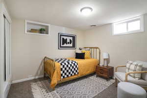 Carpeted bedroom featuring baseboards