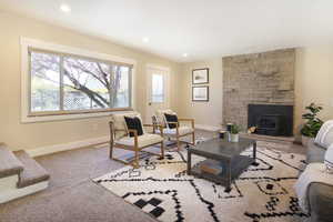 Living room with baseboards, recessed lighting, and carpet floors
