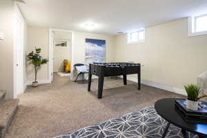 Playroom featuring plenty of natural light, carpet, and a textured ceiling