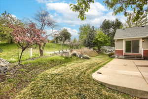 View of back yard looking towards golf course, featuring a patio and entry steps