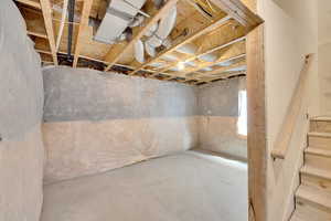 Unfinished below grade area featuring stairs