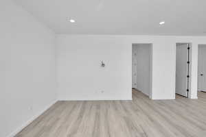 Unfurnished room with recessed lighting, baseboards, and light wood-type flooring