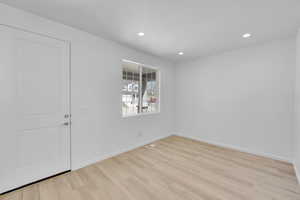 Empty room with light wood-type flooring, recessed lighting, baseboards, and visible vents