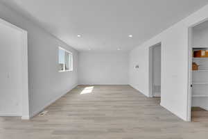 Unfurnished room with light wood-style floors and recessed lighting