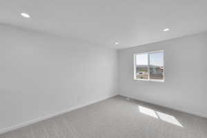 Empty room featuring recessed lighting, carpet flooring, baseboards, and visible vents