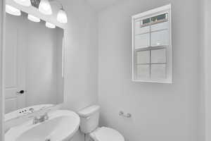 Half bath with toilet and a sink