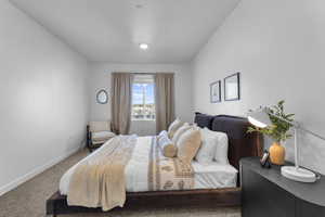 Carpeted bedroom featuring baseboards