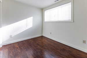 Empty room with baseboards and wood finished floors