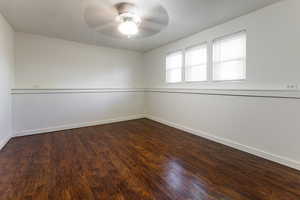 Unfurnished room with baseboards, a ceiling fan, and wood finished floors