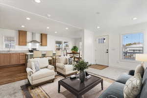 Living area featuring light wood-style floors, baseboards, and recessed lighting