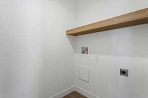 Washroom with laundry area, baseboards, hookup for a washing machine, electric dryer hookup, and dark wood finished floors