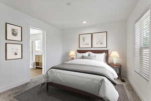 Bedroom featuring carpet flooring, recessed lighting, baseboards, and ensuite bath