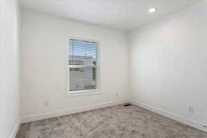 Unfurnished room with carpet floors, recessed lighting, baseboards, and visible vents