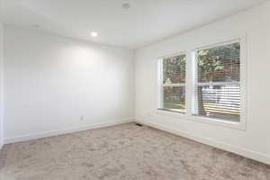 Unfurnished room with carpet flooring, recessed lighting, baseboards, and visible vents