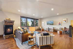 Living area featuring recessed lighting, wood finished floors, and a fireplace
