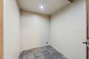 Laundry area with stone finish floor