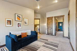 Living room featuring baseboards, carpet, and washer / dryer
