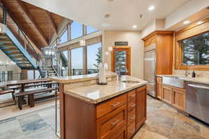 Kitchen featuring a sink, appliances with stainless steel finishes, and a chandelier