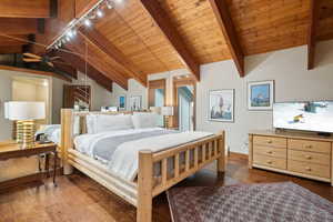 Bedroom with wood-type flooring, wooden ceiling, and lofted ceiling with beams