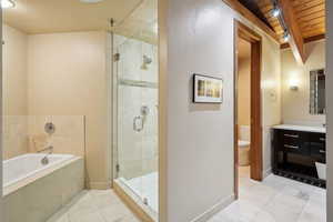 Full bath with a garden tub, vanity, wooden ceiling, a stall shower, and tile patterned floors
