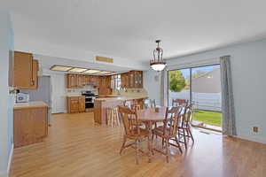 Dining area featuring baseboards, light wood-style flooring, and visible vents